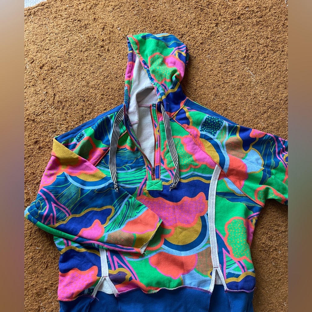 Out from under colorful hoodie